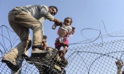 Syrian Refugees Going Over The Border With Children