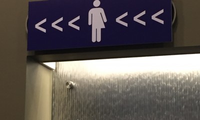 Gender-neutral bathroom sign, translation services