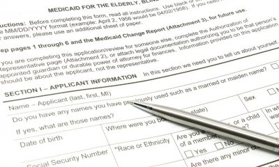 8158691 - a medicaid application ready to be filled out with a silver pen.
