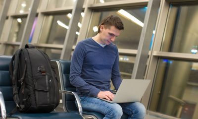 40768184 - businessman using laptop or notebook computer while sitting on the chair at the airport