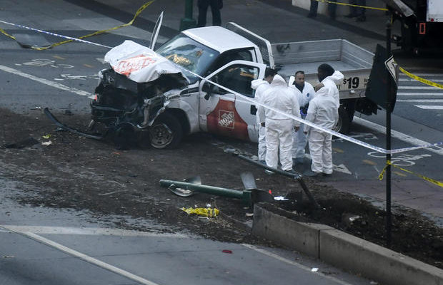 Investigators inspect a truck following a shooting incident in New York on October 31, 2017. 
Several people were killed and numerous others injured in New York on Tuesday after a vehicle plowed into a pedestrian and bike path in Lower Manhattan, police said. "The vehicle struck multiple people on the path," police tweeted. "The vehicle continued south striking another vehicle. The suspect exited the vehicle displaying imitation firearms & was shot by NYPD." / AFP PHOTO / DON EMMERT        (Photo credit should read DON EMMERT/AFP/Getty Images)